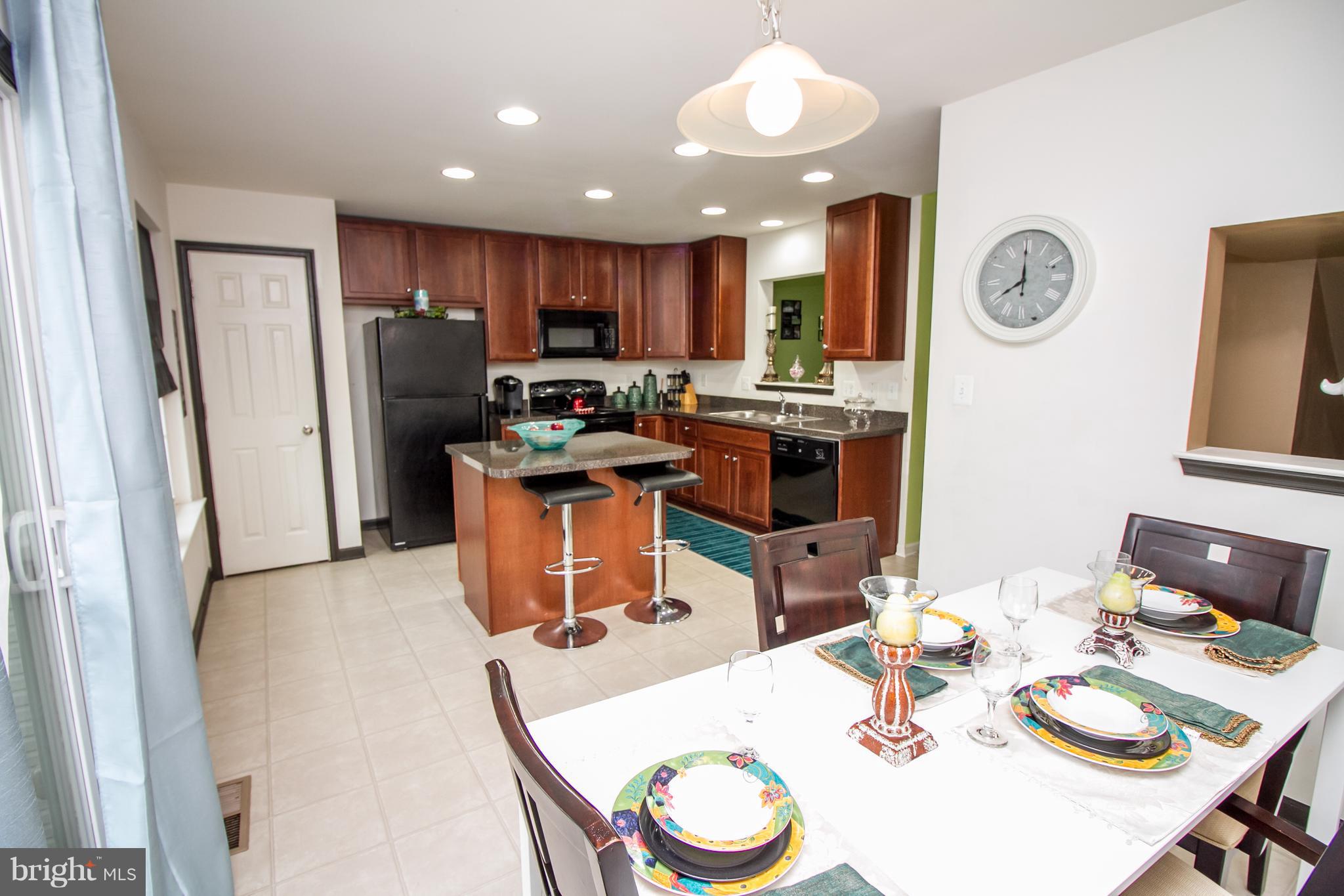 1217 Mare Street Ranson, WV 25438 - Photo 7 of 23 a dining room with furniture a window and stainless steel appliances