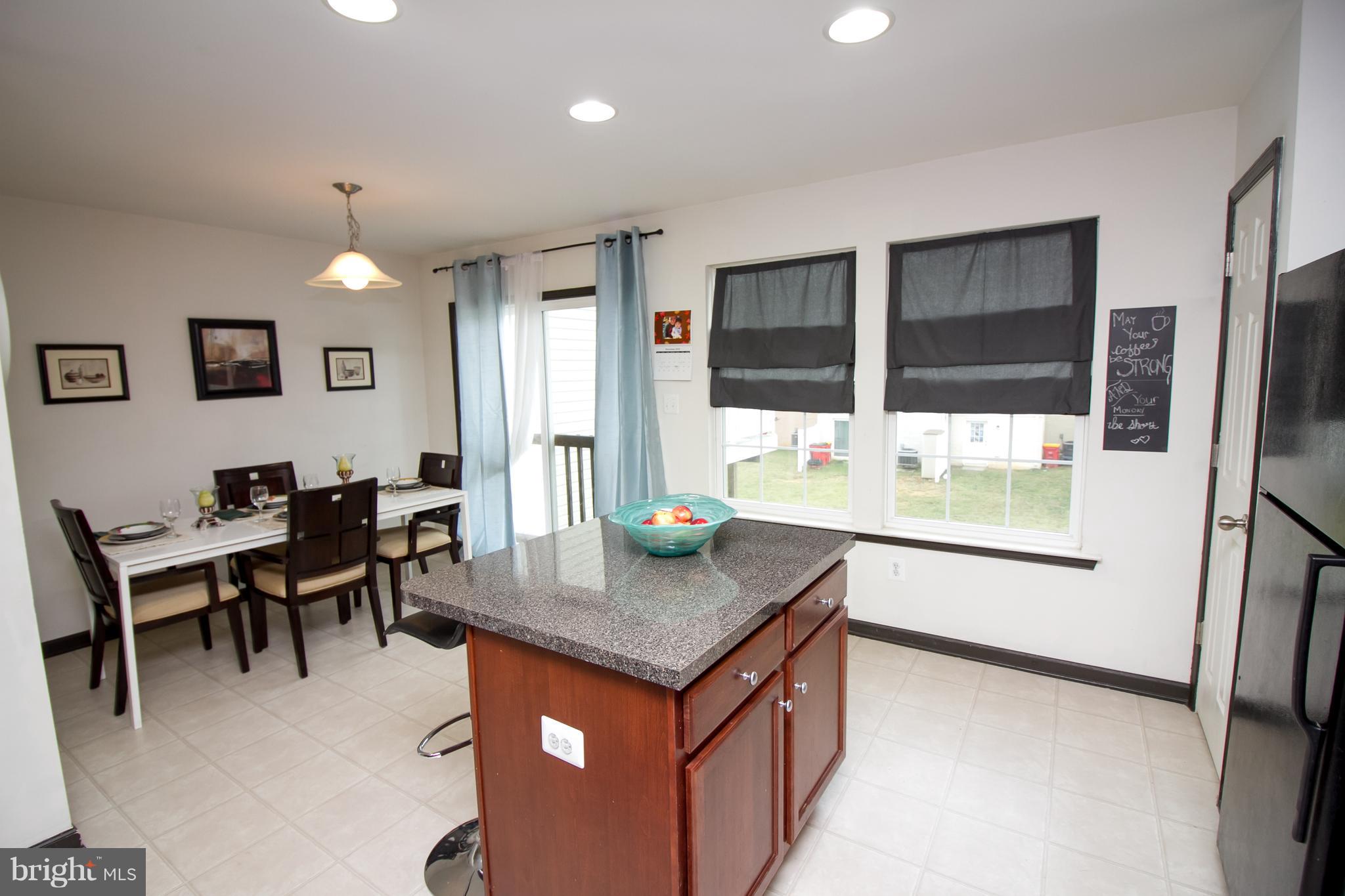 1217 Mare Street Ranson, WV 25438 - Photo 8 of 23 a living room with granite countertop furniture a dining table and chairs with kitchen view