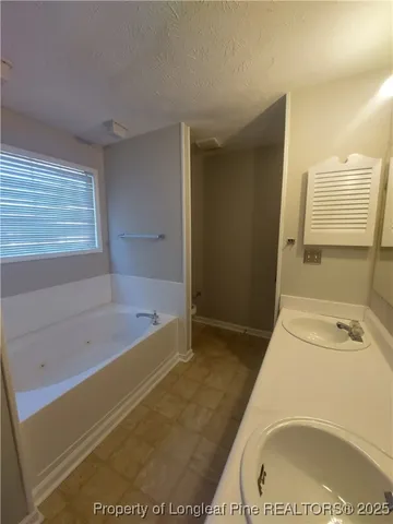 a bathroom with a bathtub and a sink