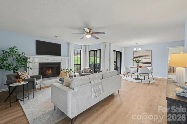 a living room with furniture a fireplace and a flat screen tv