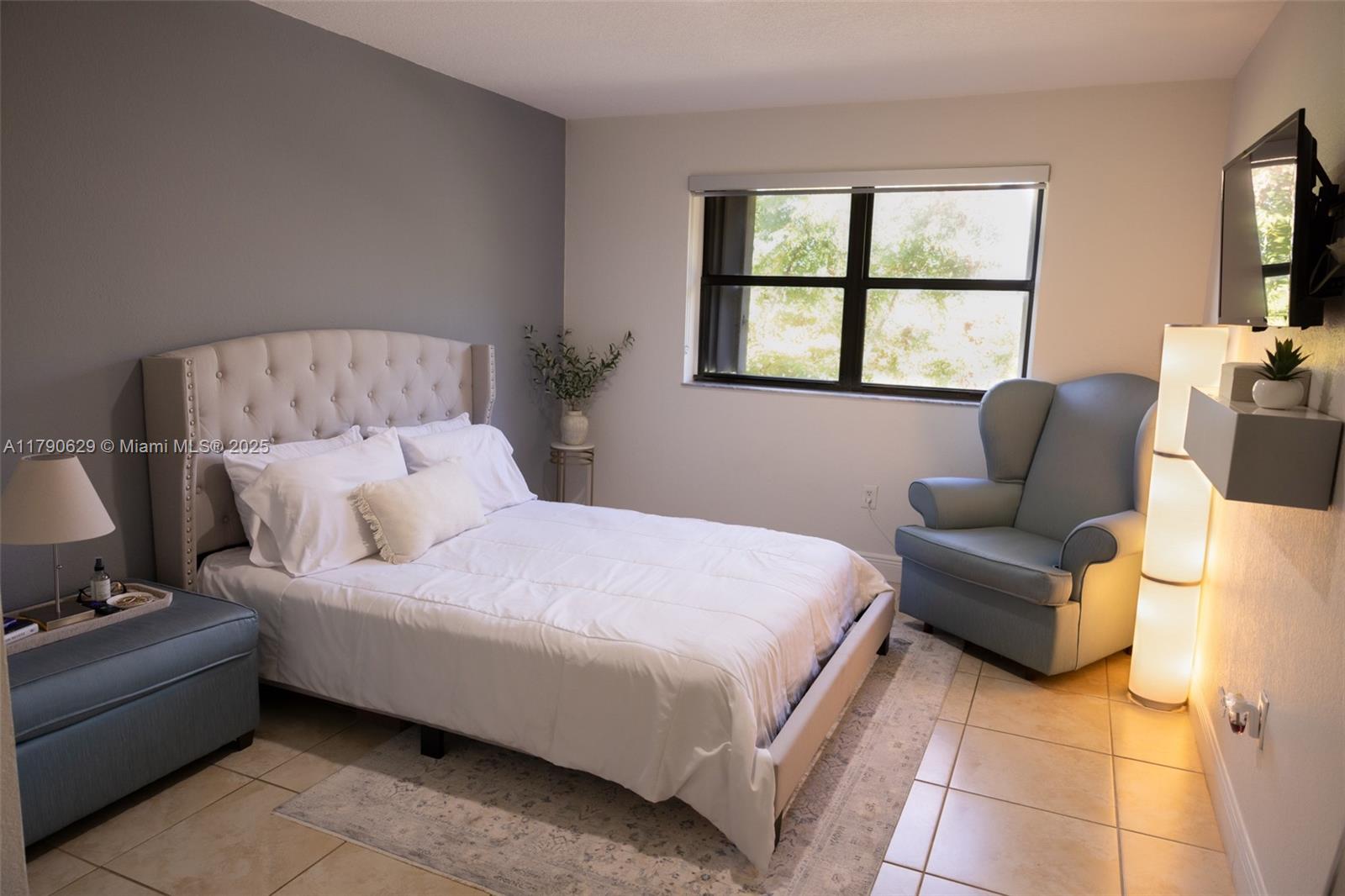 West End Miami, FL 33193 - Photo 14 of 23 a bedroom with a bed couch and window