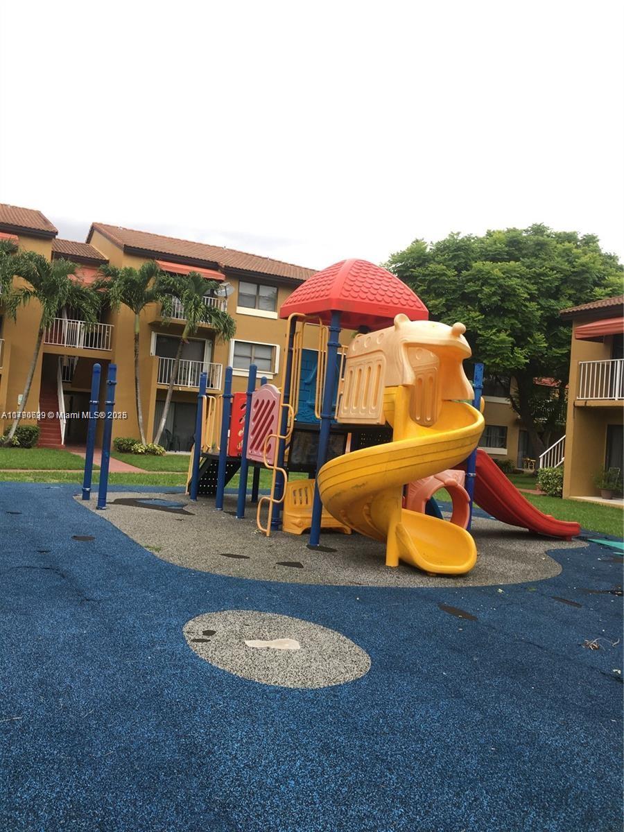 West End Miami, FL 33193 - Photo 22 of 23 an outdoor sitting area with a table and chairs