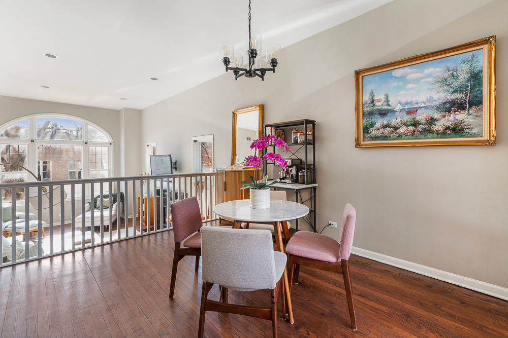 1002 West Altgeld Street, Unit 1002 Chicago, IL 60614 - Photo 11 of 39 a view of a dining room with furniture wooden floor and a chandelier
