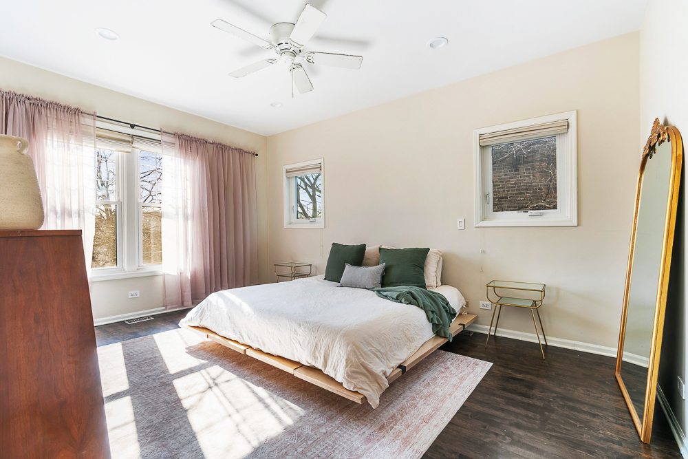 1002 West Altgeld Street, Unit 1002 Chicago, IL 60614 - Photo 12 of 39 a bedroom with a bed and wooden floor