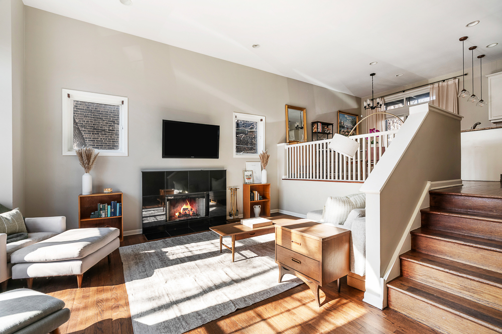 1002 West Altgeld Street, Unit 1002 Chicago, IL 60614 - Photo 2 of 39 a living room with furniture and a fireplace