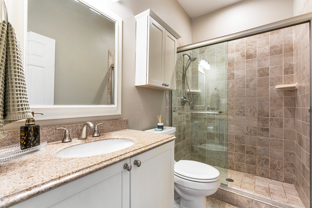 1002 West Altgeld Street, Unit 1002 Chicago, IL 60614 - Photo 23 of 39 a bathroom with a granite countertop sink toilet and shower