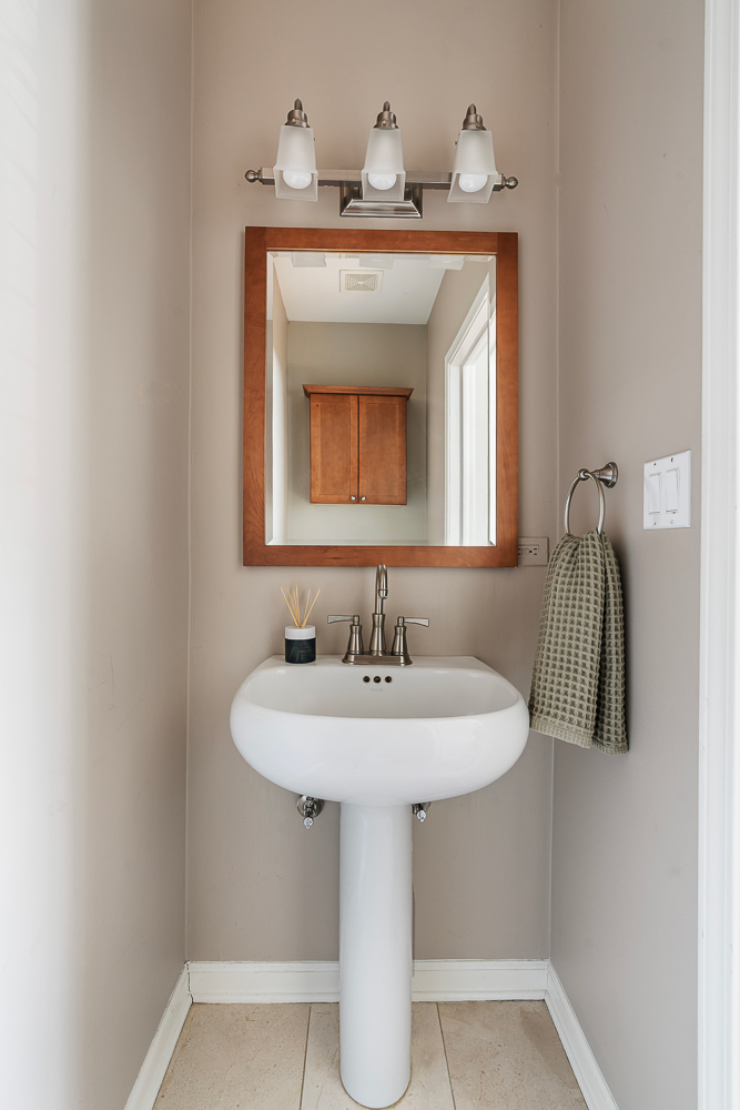 1002 West Altgeld Street, Unit 1002 Chicago, IL 60614 - Photo 27 of 39 a bathroom with a sink and a mirror
