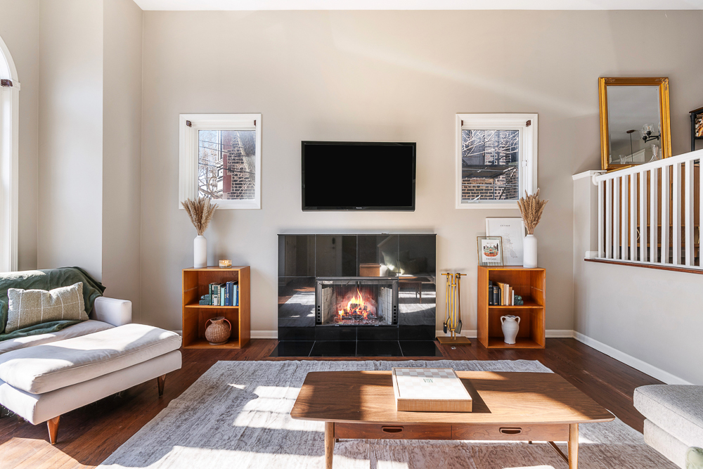 1002 West Altgeld Street, Unit 1002 Chicago, IL 60614 - Photo 5 of 39 a living room with furniture a flat screen tv and a fireplace
