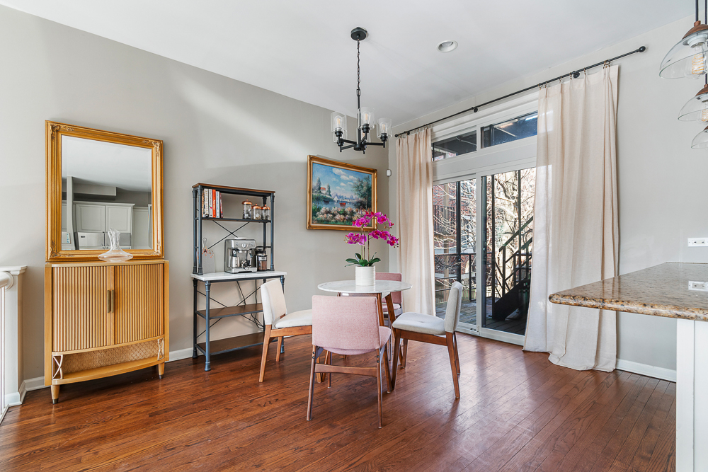 1002 West Altgeld Street, Unit 1002 Chicago, IL 60614 - Photo 8 of 39 a dining room with wooden floor a chandelier a glass table and chairs