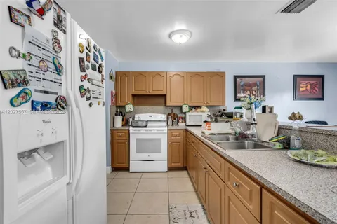 a kitchen with stainless steel appliances a stove a sink and a refrigerator