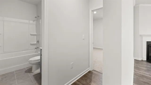 a bathroom with a granite countertop toilet a sink and bathtub