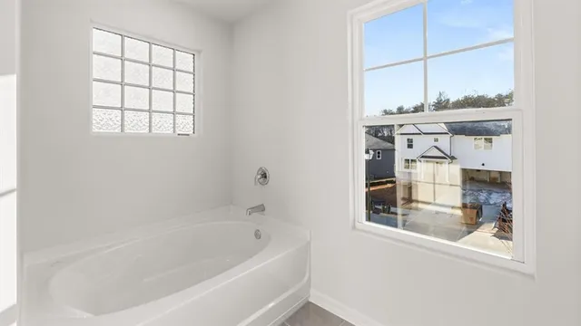 a white bath tub sitting next to a window