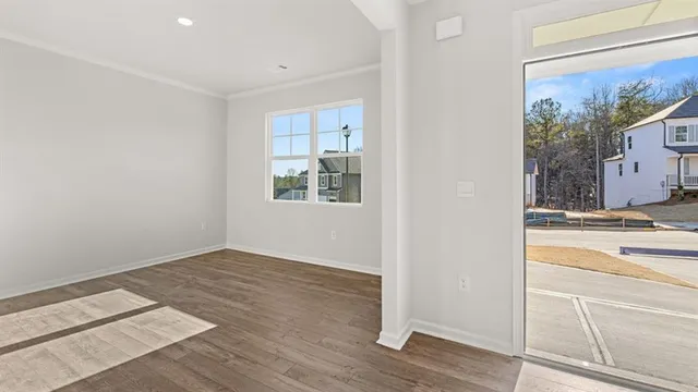 a view of a kitchen with wooden floor and a window