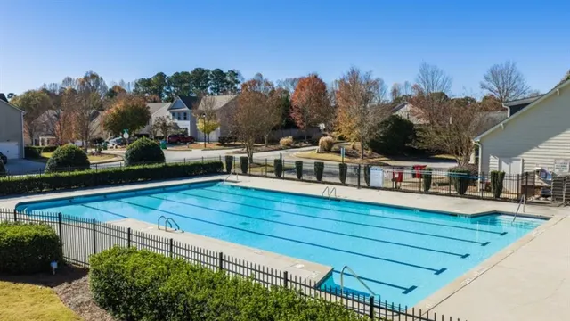 a view of a tennis ground with large trees