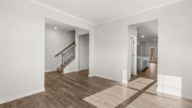 a view of entryway and hall with wooden floor