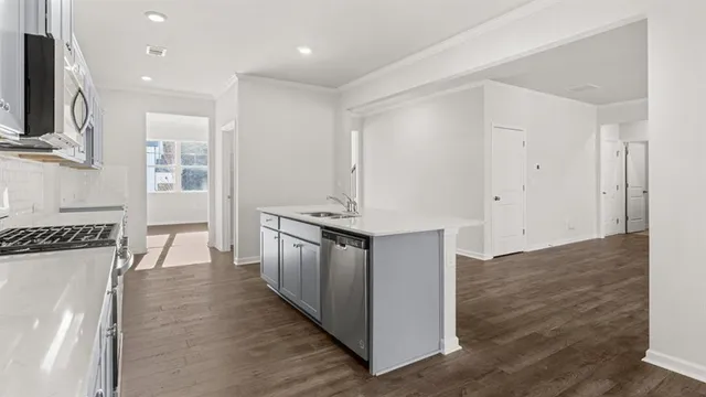 a kitchen with granite countertop a sink and a stove top oven
