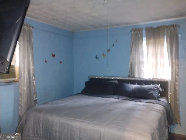 a bedroom with a bed and window