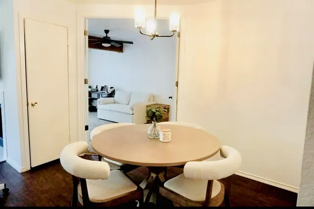 a dining room with furniture and wooden floor