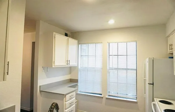 a bathroom with a shower and a sink