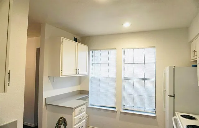 a bathroom with a shower and a sink