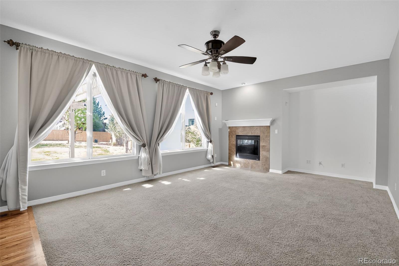 11036 Glengate Circle Highlands Ranch, CO 80130 - Photo 11 of 31 a view of an empty room with a window and a fireplace
