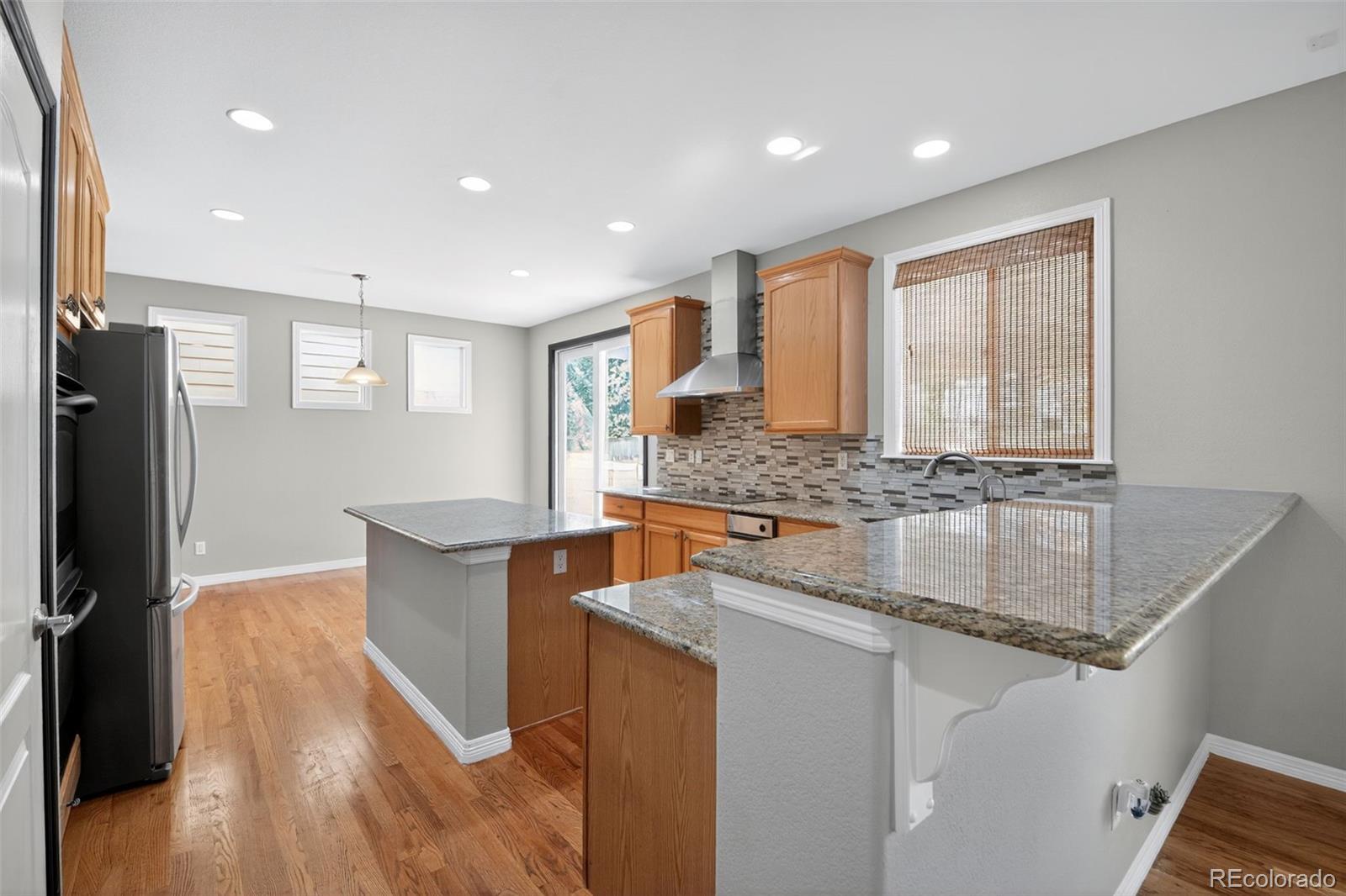 11036 Glengate Circle Highlands Ranch, CO 80130 - Photo 17 of 31 a kitchen with stainless steel appliances granite countertop a sink stove and refrigerator