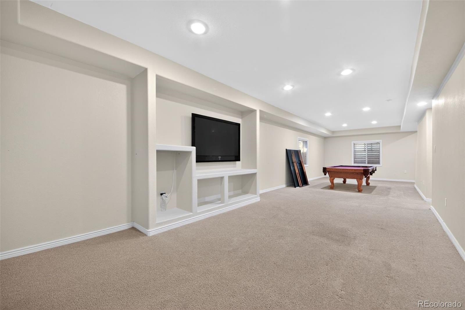 11036 Glengate Circle Highlands Ranch, CO 80130 - Photo 29 of 31 a view of a livingroom with an empty space and a flat screen tv
