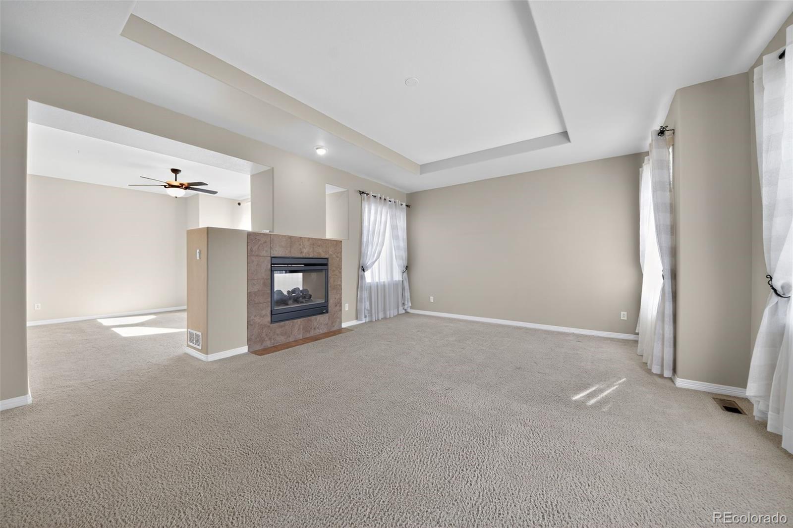 11036 Glengate Circle Highlands Ranch, CO 80130 - Photo 7 of 31 a view of a livingroom with an empty space and a fireplace