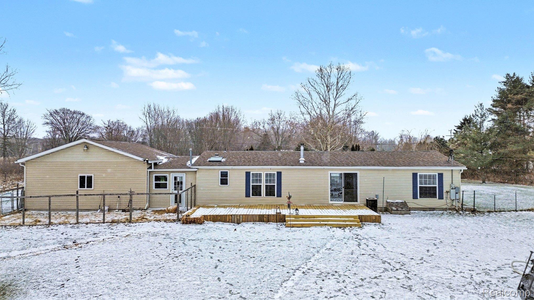 4458 Palms Road Casco, MI 48064 - Photo 29 of 32 Snow covered house with a wooden deck
