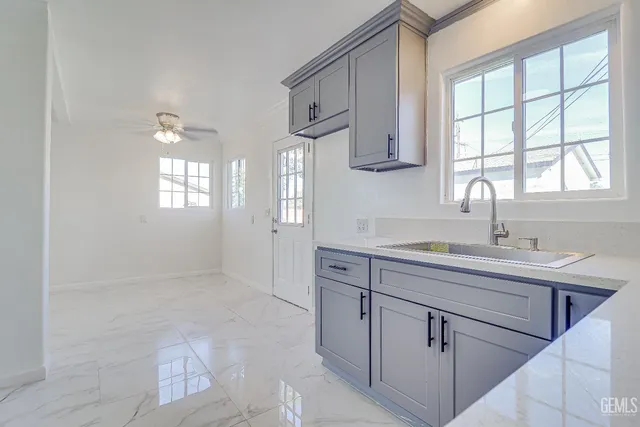 a kitchen with a sink cabinets and window