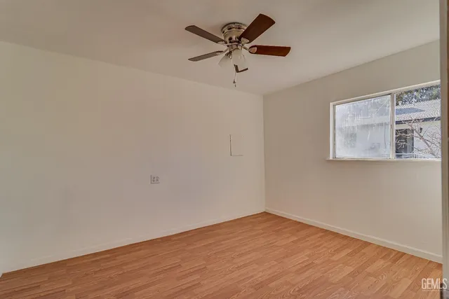 a kitchen with white cabinets and sink