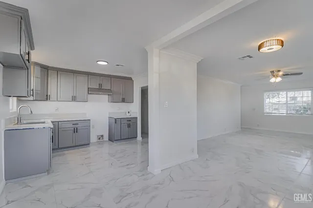 a kitchen with a sink cabinets and window