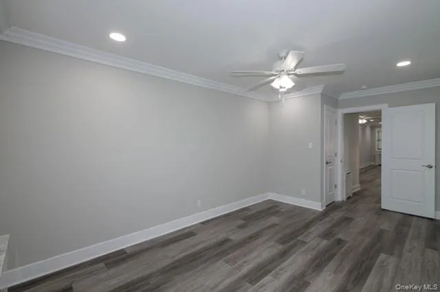 a view of a room with wooden floor and a ceiling fan