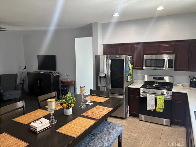 a kitchen with a dining table and chairs