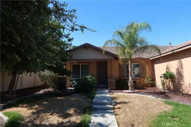 a front view of a house with a yard garage and outdoor seating