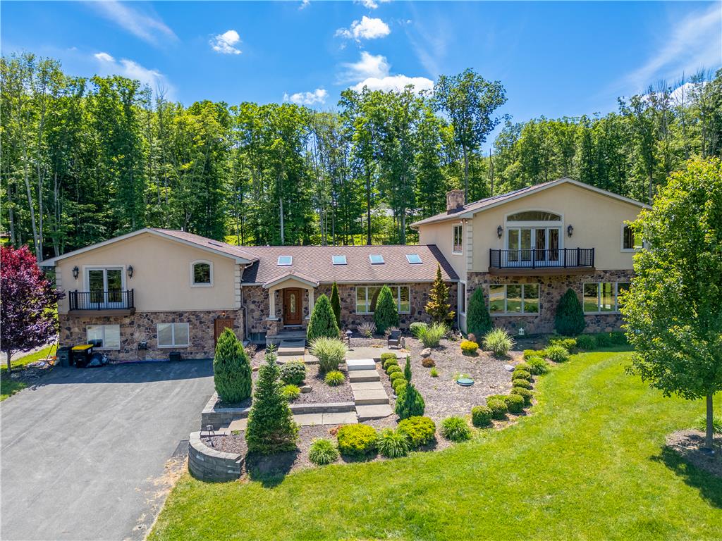 374 Packer Drive Weatherly, PA 18255 - Photo 30 of 30 A grand façade featuring stone accents, stucco finishes, and multiple balconies amidst lush, verdant landscaping.