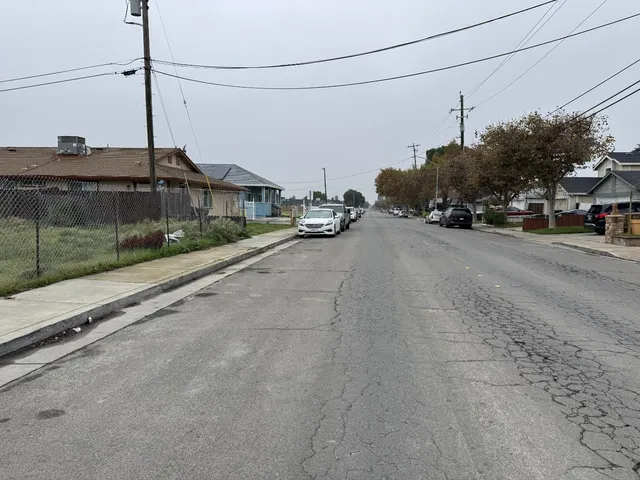 a view of a city street with a car parked on the road