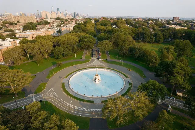 an aerial view of a house with outdoor space and trees all around