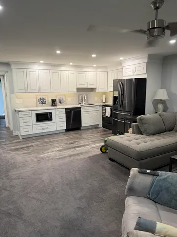 a living room with furniture and kitchen view
