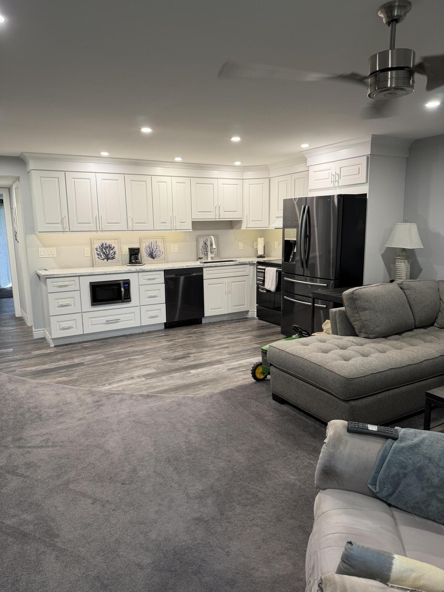 a living room with furniture and kitchen view
