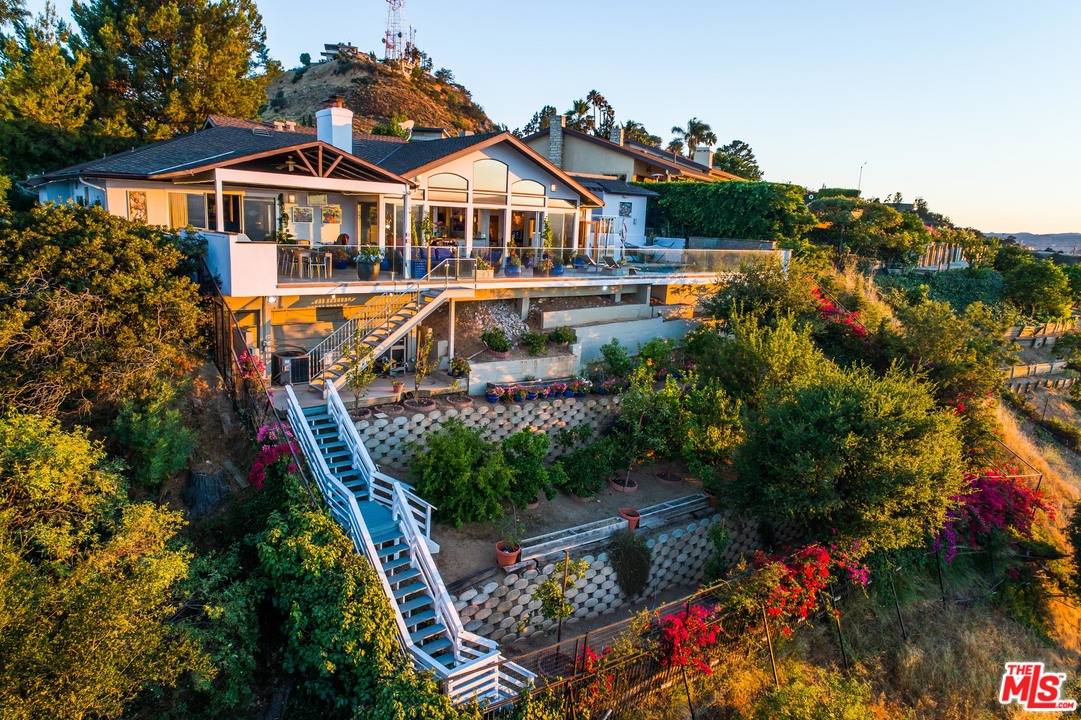 8647 Edwin Drive Los Angeles, CA 90046 - Photo 2 of 32 a front view of a house with a yard and fountain