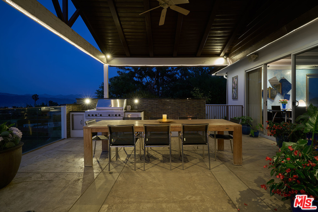 8647 Edwin Drive Los Angeles, CA 90046 - Photo 15 of 32 a patio with a table and chairs