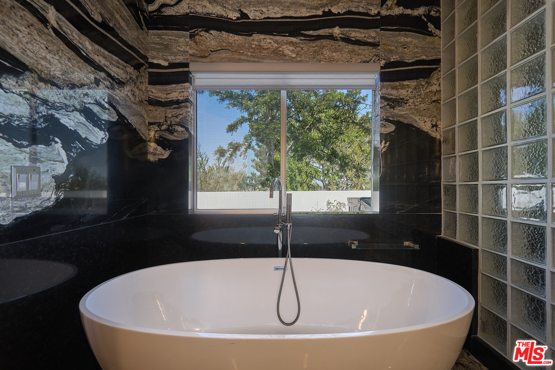 8647 Edwin Drive Los Angeles, CA 90046 - Photo 17 of 32 a white bath tub sitting in front of a window