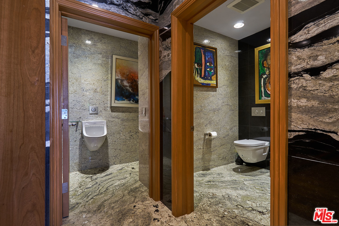 8647 Edwin Drive Los Angeles, CA 90046 - Photo 18 of 32 a bathroom with a granite countertop shower and a toilet