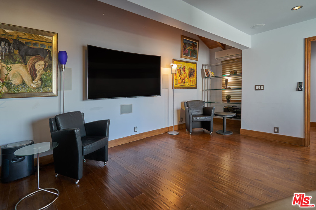 8647 Edwin Drive Los Angeles, CA 90046 - Photo 25 of 32 a view of a livingroom with furniture and a flat screen tv