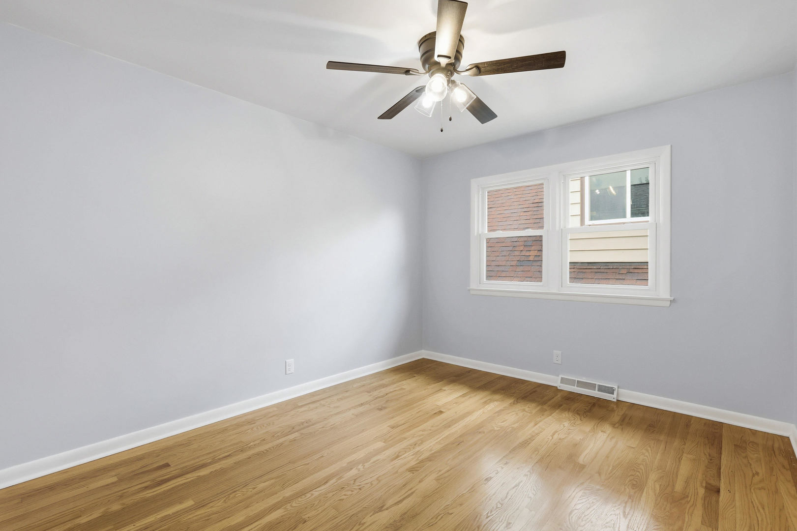 2528 28th Street Moline, IL 61265 - Photo 23 of 35 a view of a room with wooden floor and a ceiling fan