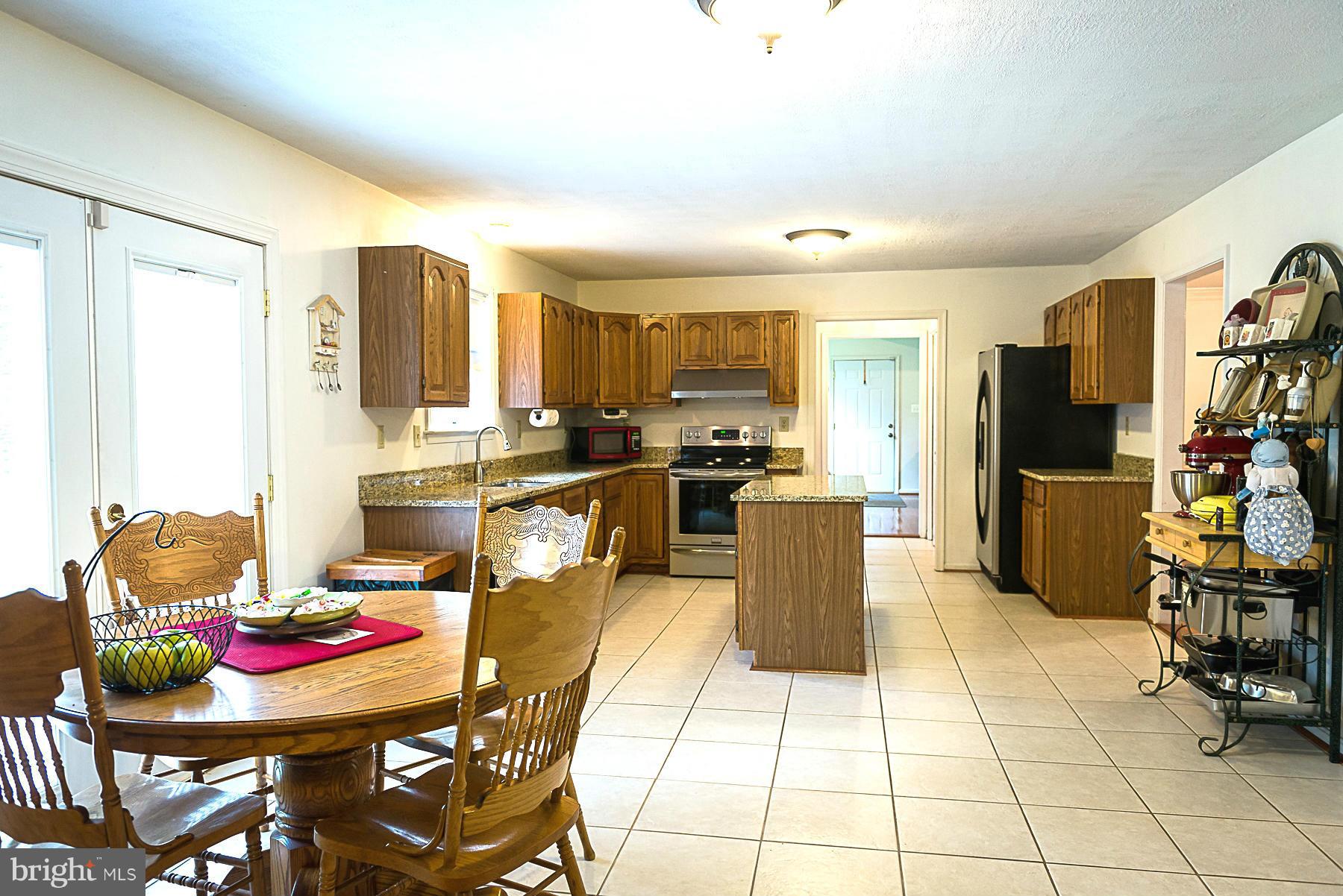 7105 Henson Landing Road Welcome, MD 20693 - Photo 6 of 30 Kitchen granite tops, island, and table area