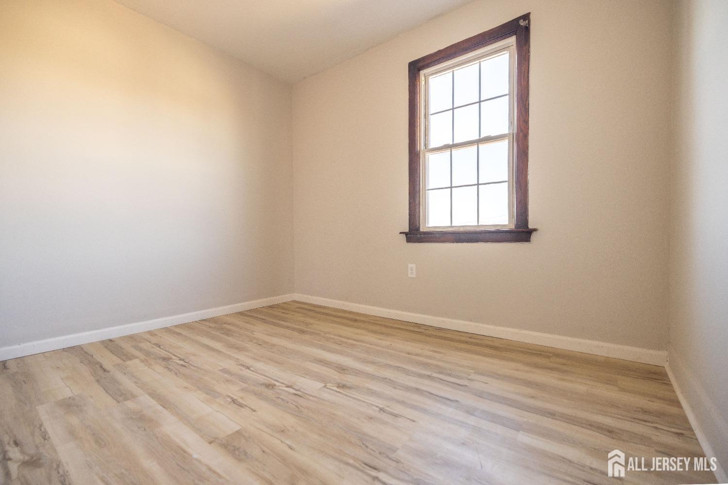 60 Sampson Street Garfield, NJ 07026 - Photo 8 of 9 an empty room with a window
