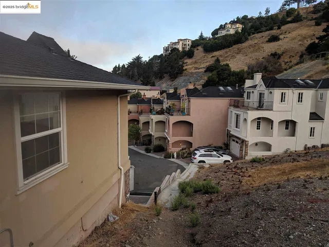 a view of a house with backyard and trees