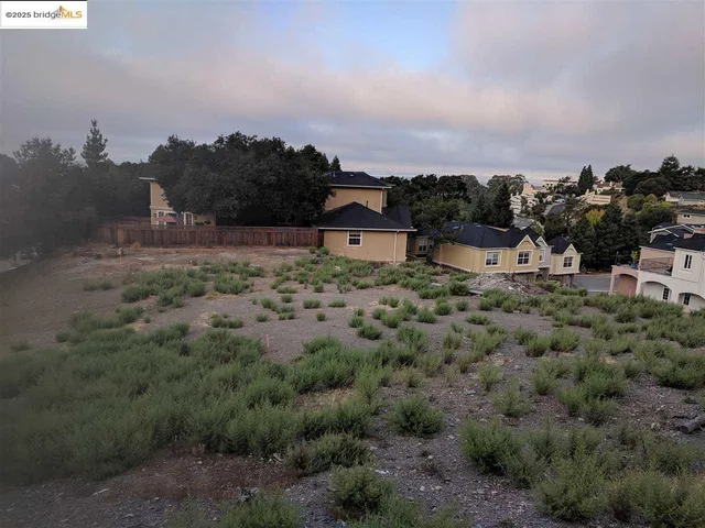 a view of a houses with a yard and mountain view